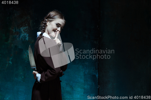 Image of Portrait of a young girl in school uniform as killer woman