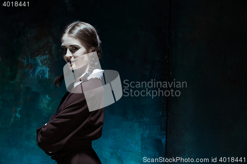 Image of Portrait of a young smiling girl in school uniform as killer woman