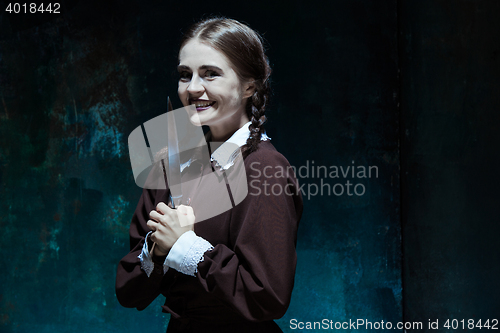 Image of Portrait of a young girl in school uniform as killer woman