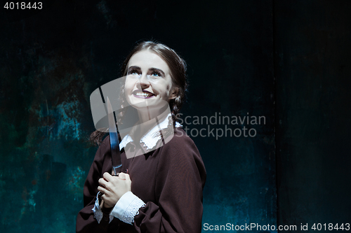 Image of Portrait of a young girl in school uniform as killer woman