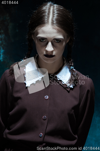 Image of Portrait of a young girl in school uniform as killer woman