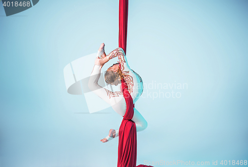 Image of Graceful gymnast performing aerial exercise