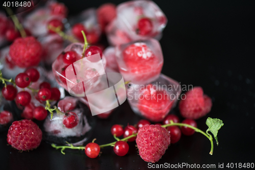 Image of Frozen berries on wooden table