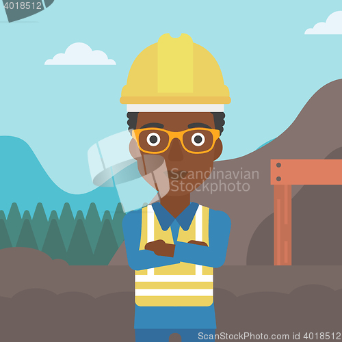 Image of Miner with mining equipment on background.