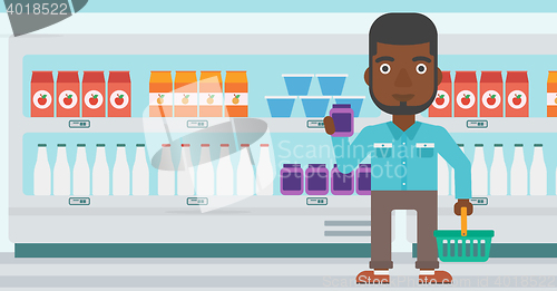 Image of Customer with shopping basket and tube of cream.