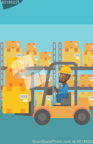 Image of Warehouse worker moving load by forklift truck.