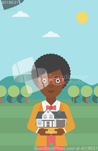 Image of Woman holding house model vector illustration.