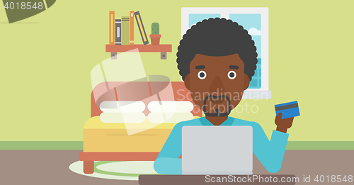 Image of Man shopping online using his laptop.
