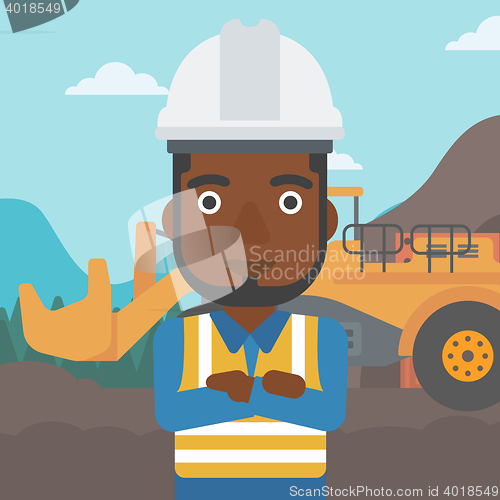 Image of Miner with mining equipment on background.