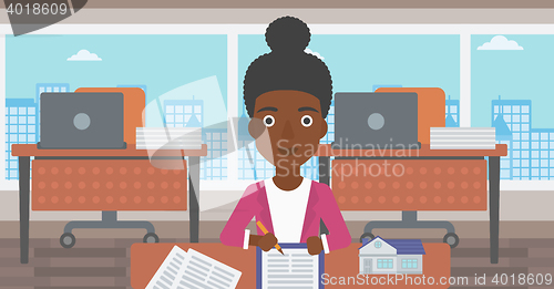 Image of Real estate agent signing contract.