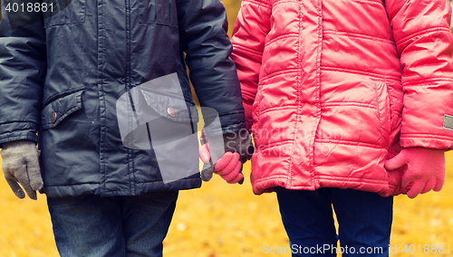 Image of close up of girl and boy holding hands outdoors