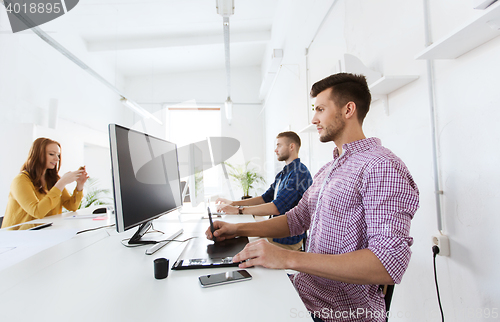 Image of man or designer with computer and tablet at office