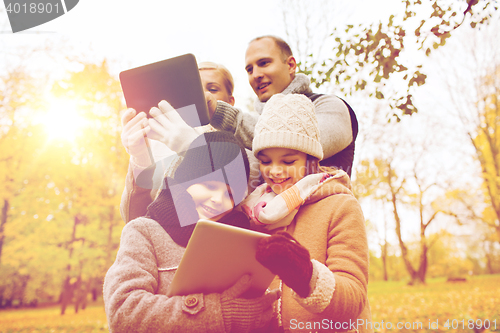 Image of happy family with tablet pc in autumn park