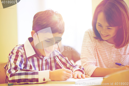 Image of group of school kids writing test in classroom