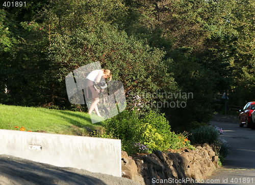 Image of woman working the lawn