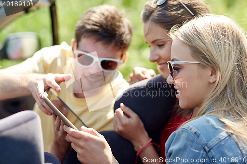 Image of friends with tablet pc driving in cabriolet car