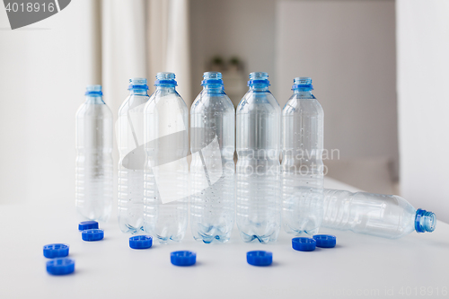 Image of close up of empty water bottles and caps on table