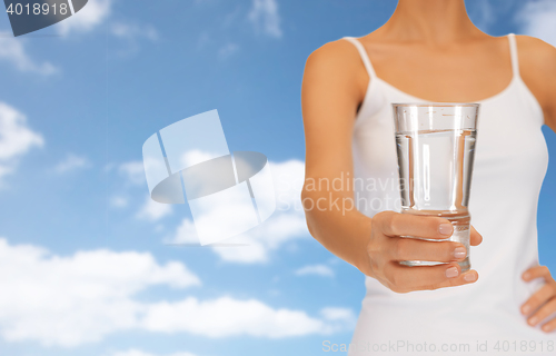Image of woman hand holding glass of water