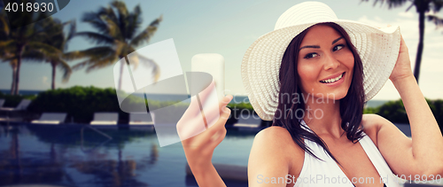 Image of young woman taking selfie with smartphone