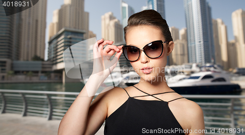 Image of beautiful young woman in elegant black sunglasses