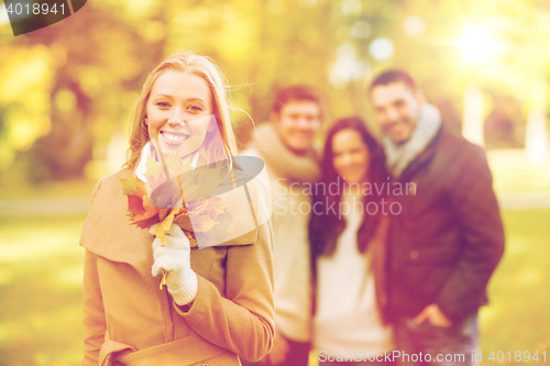 Image of group of friends having fun in autumn park