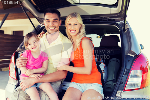 Image of happy family with hatchback car at home parking