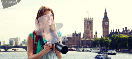 Image of woman with backpack and camera over london big ben