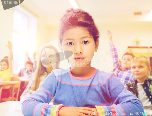 Image of little school girl over classroom background