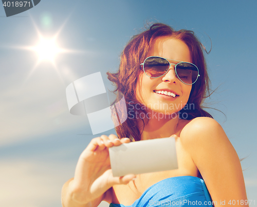 Image of happy smiling woman using phone camera