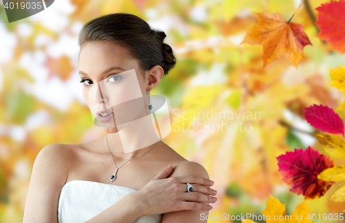 Image of beautiful woman with earring, ring and pendant