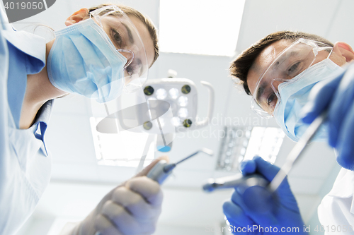 Image of close up of dentist and assistant at dental clinic