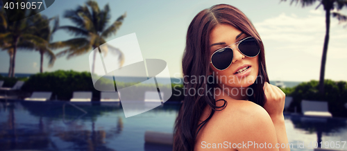 Image of young woman with sunglasses on beach