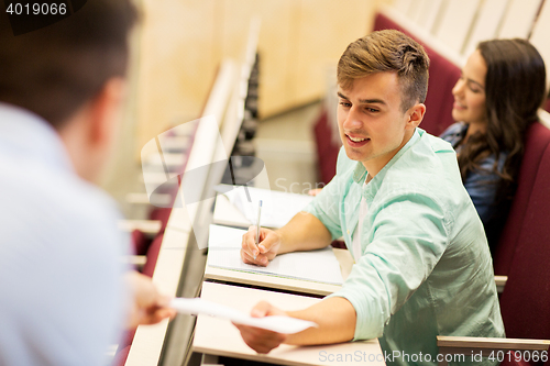 Image of teacher giving test to student boy on lecture