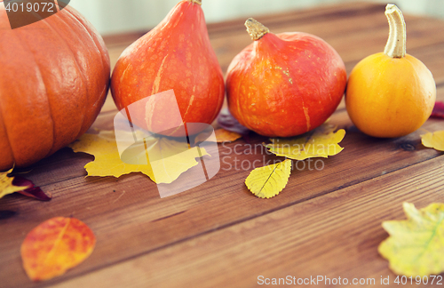 Image of close up of pumpkins on wooden table at home