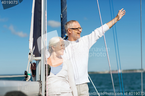 Image of senior couple hugging on sail boat or yacht in sea