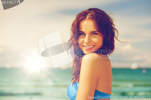 Image of happy smiling woman on the beach