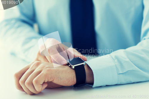 Image of close up of male hands setting smart watch