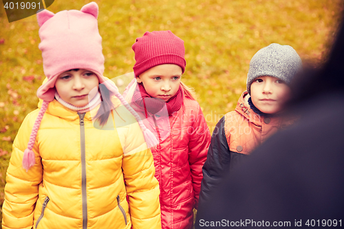 Image of sad kids being blamed for misbehavior outdoors