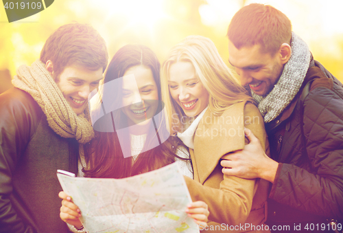 Image of couples with tourist map in autumn park