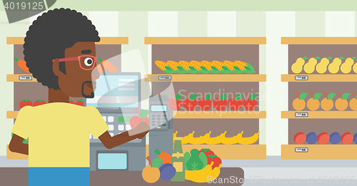 Image of Cashier standing at the checkout in supermarket.