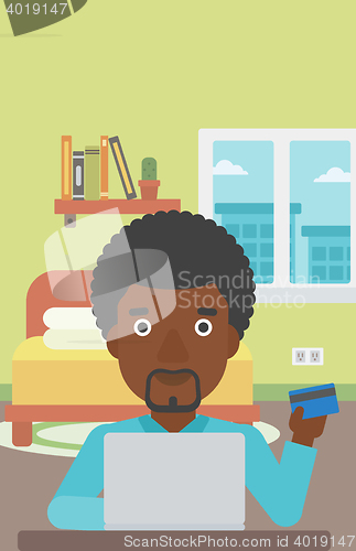 Image of Man shopping online using his laptop.