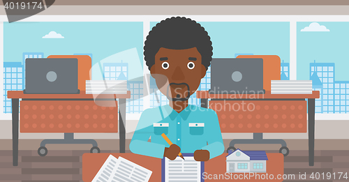 Image of Real estate agent signing contract.