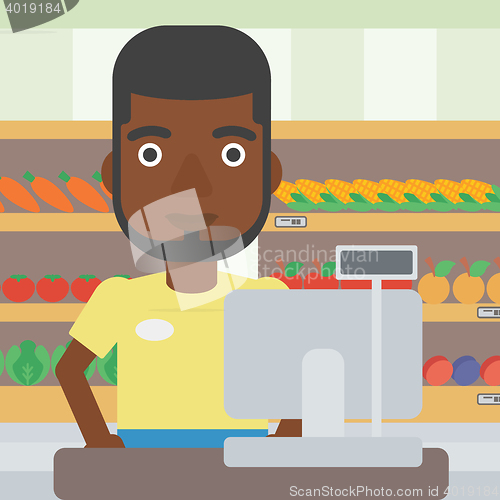 Image of Cashier standing at the checkout in supermarket.