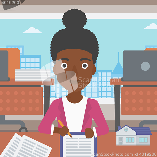 Image of Real estate agent signing contract.