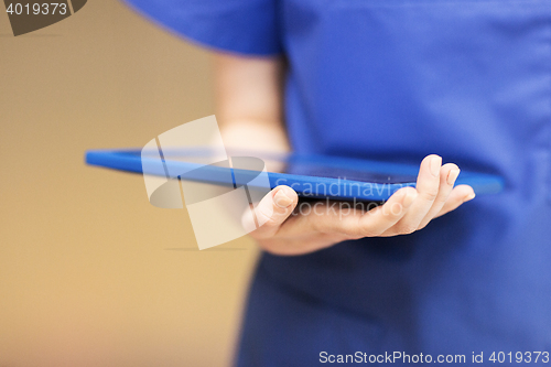 Image of close up of female doctor or nurse with tablet pc