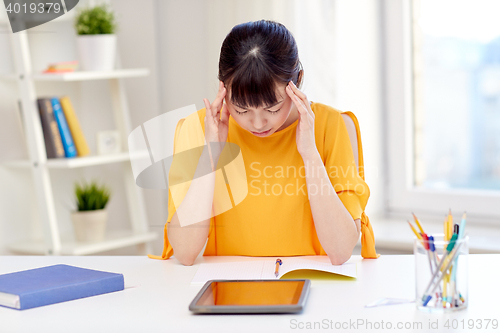 Image of tired asian woman student with tablet pc at home