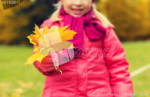 Image of close up of happy girl with autumnn maple leaves