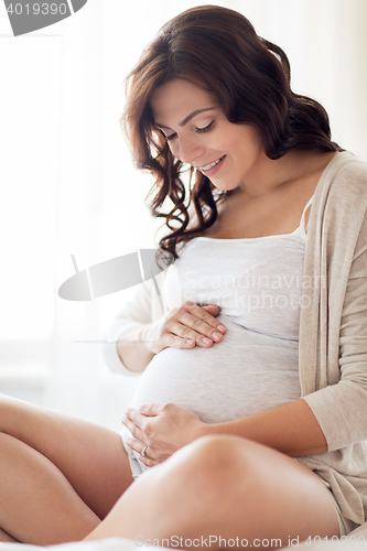 Image of close up of happy pregnant woman at home
