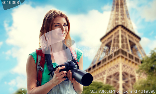 Image of woman with backpack and camera over eiffel tower