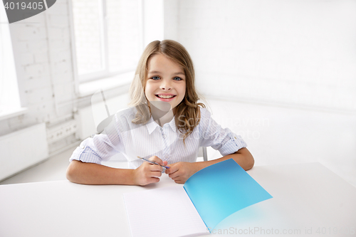 Image of happy smiling school girl with notebook and pen